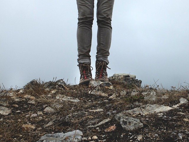 a hiker on a trail in ankle-high boots